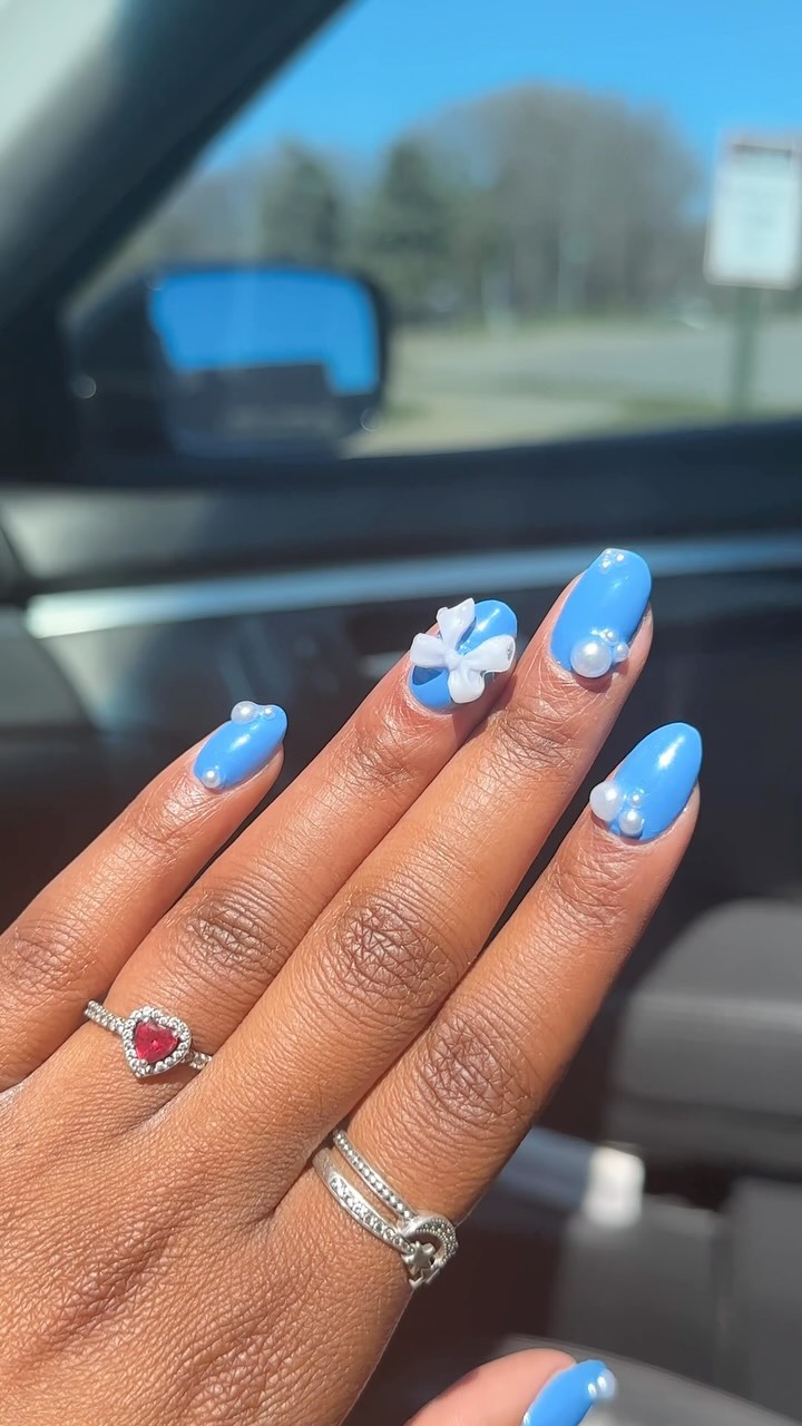 Stylish Blue Nails with Pearl and Bow Accents