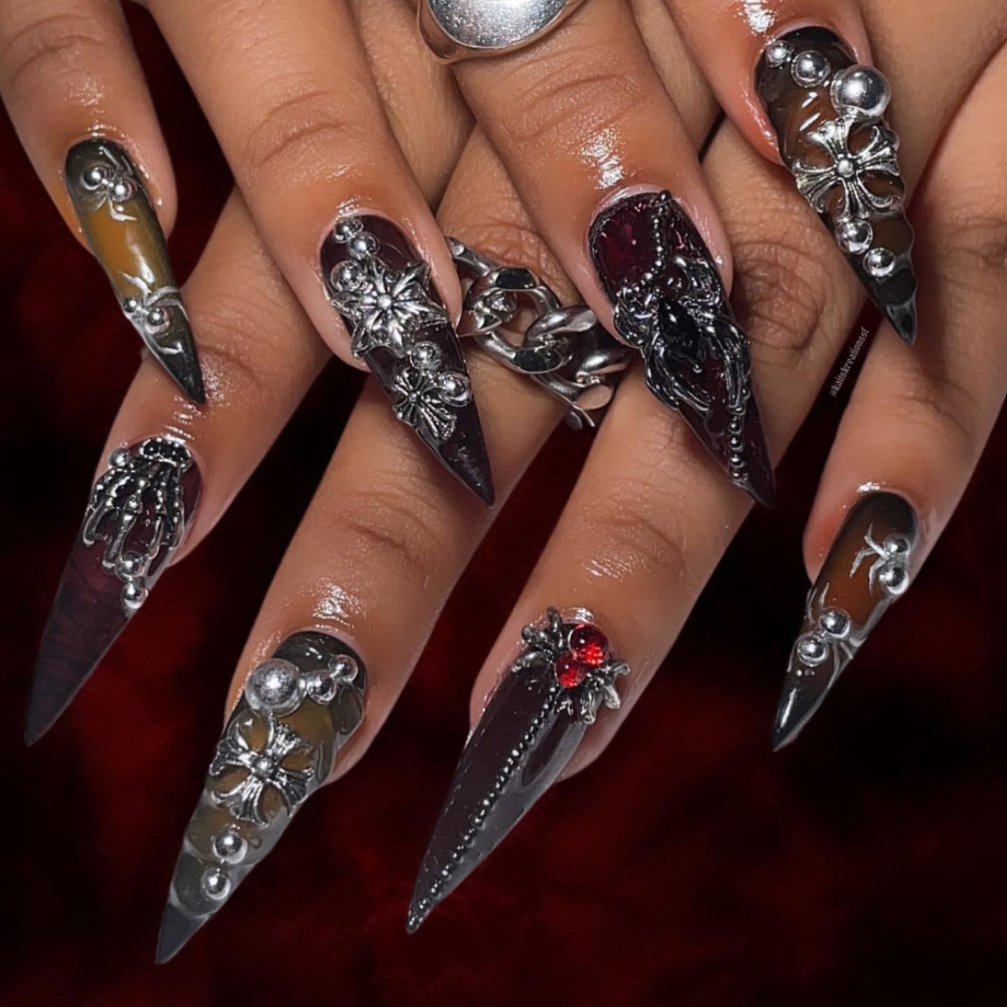Artistic Long Stiletto Nails with Silver and Gem Accents