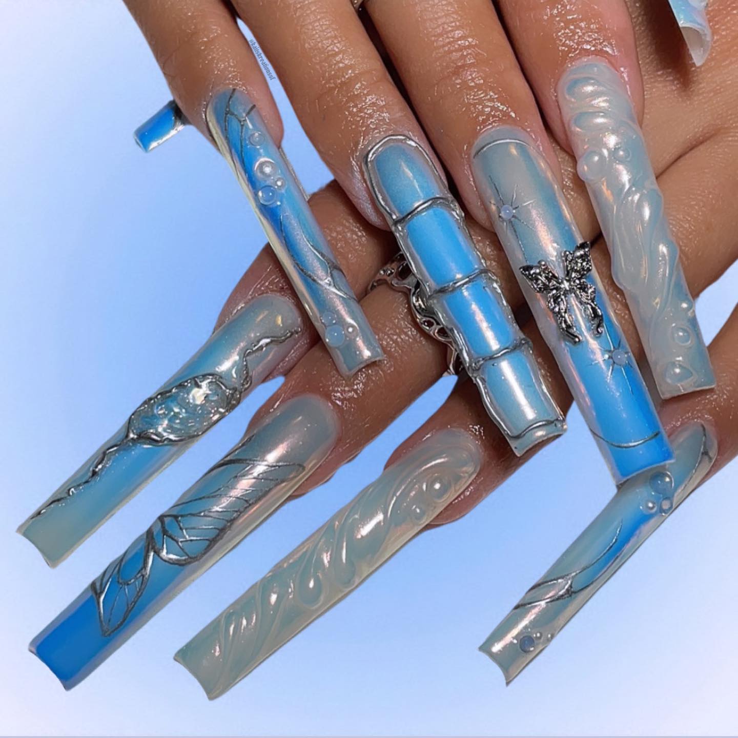 Artistic Blue and Nude Nail Design