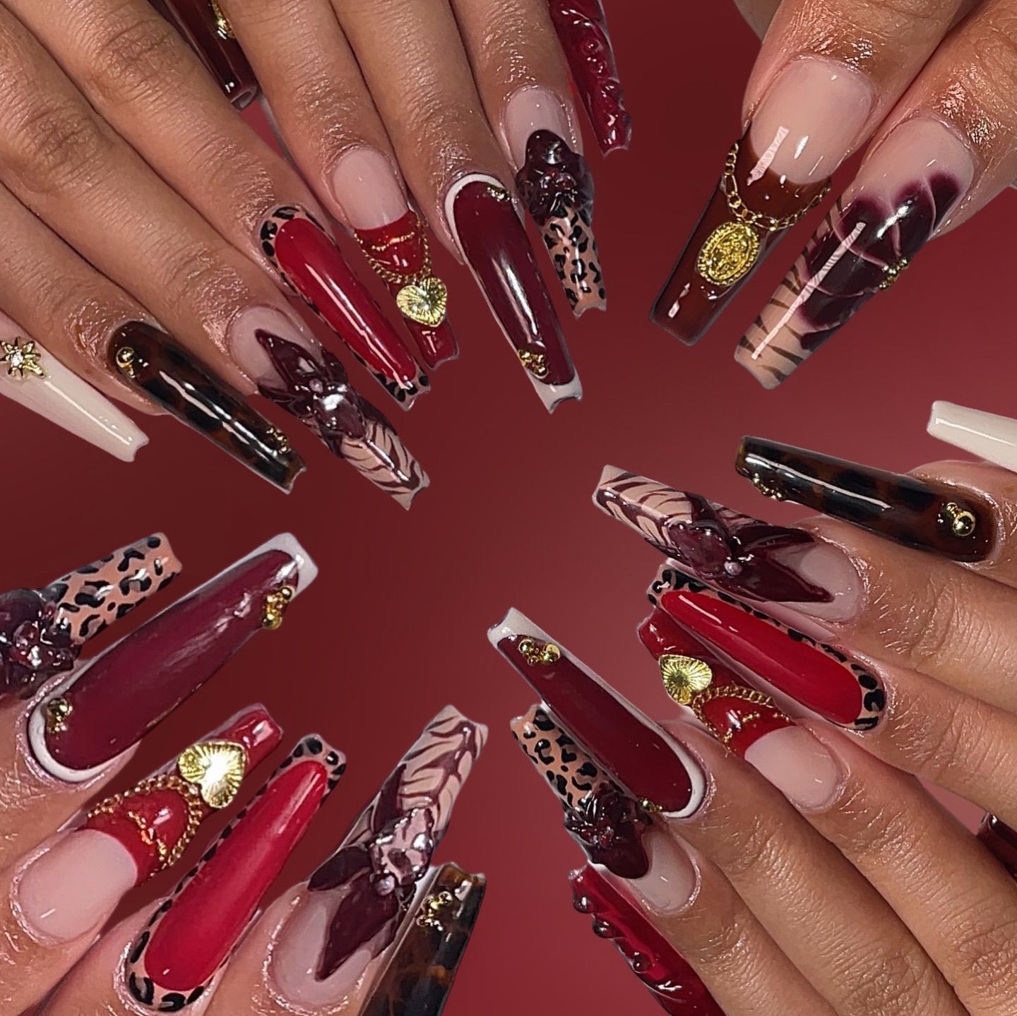 Artistic Long Red and Black Nails with Gems
