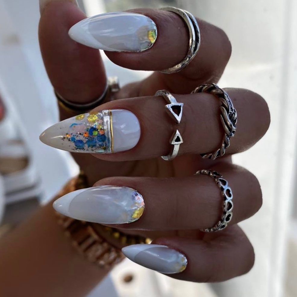 Stylish White Stiletto Nails with Glitter Accents