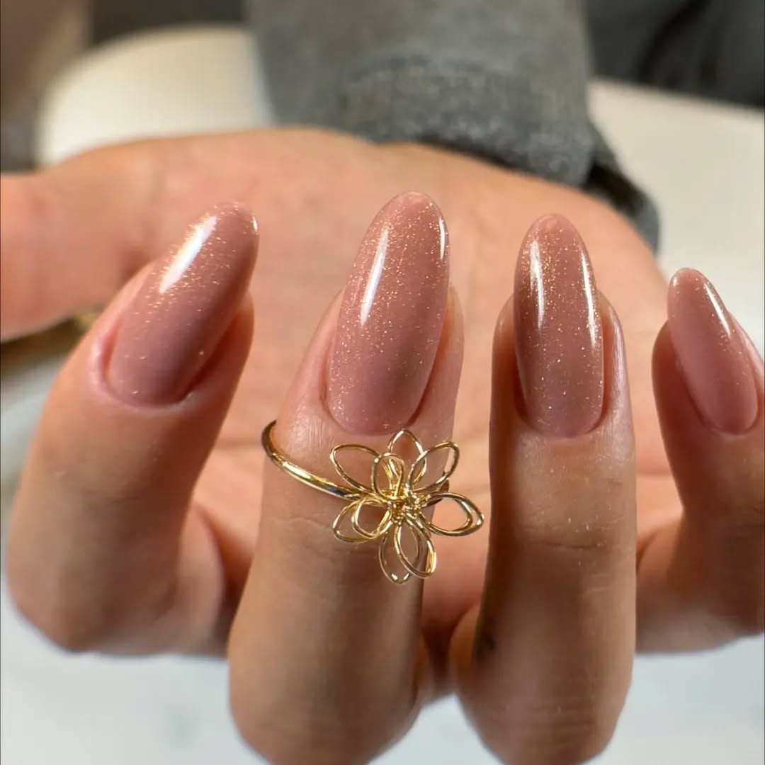 Elegant Nude Glitter Nails with Floral Ring