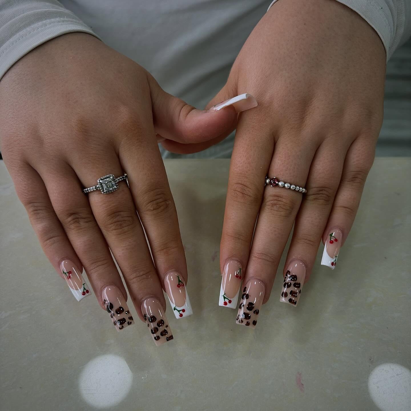 Stylish Nail Art with Leopard Print and Cherry Accents