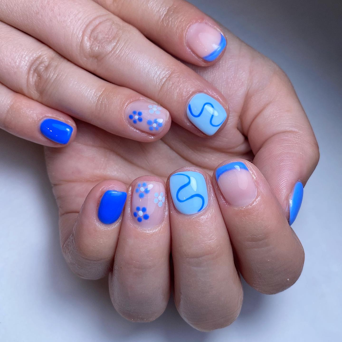 Artistic Blue and Floral Nail Design