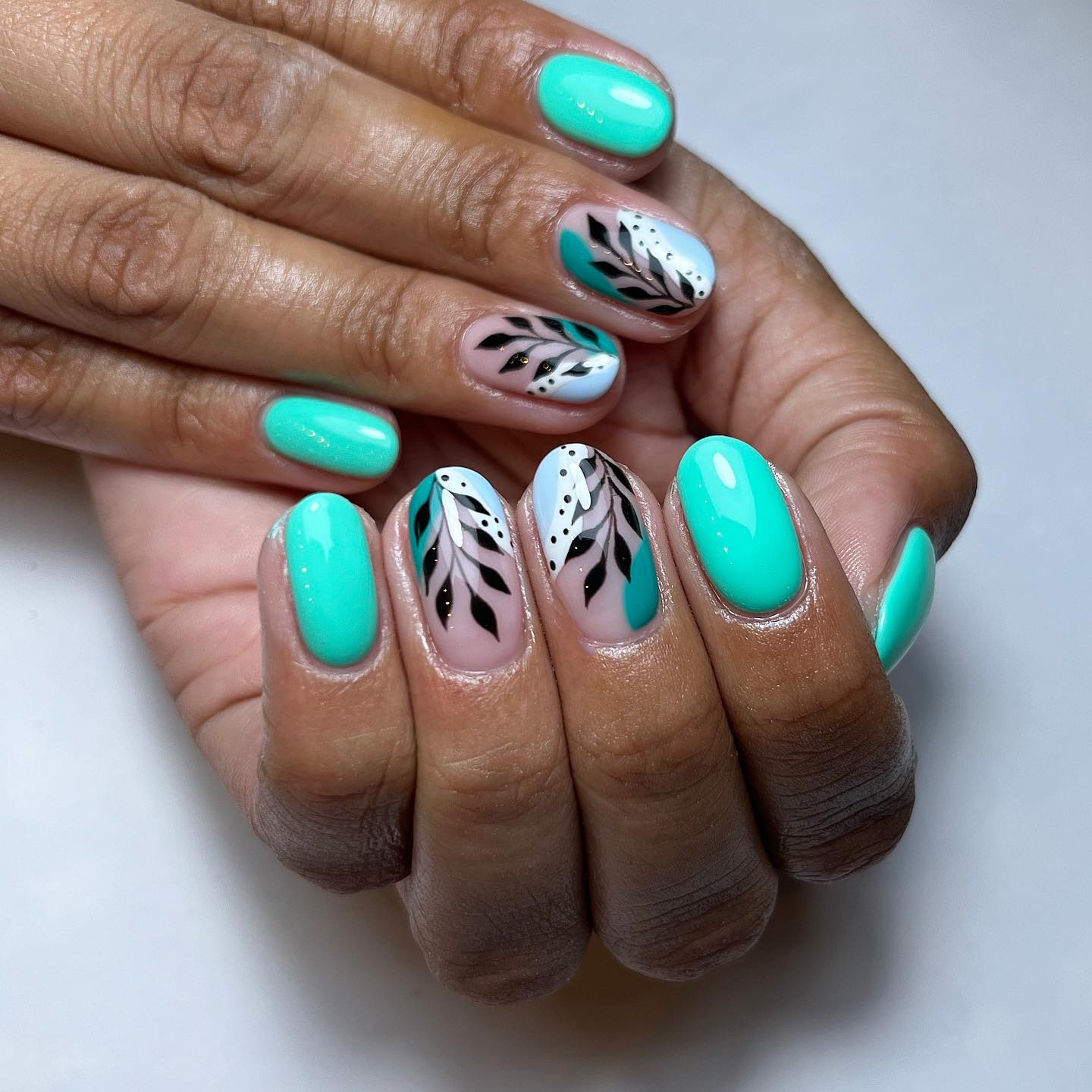 Artistic Turquoise and Black Nail Design