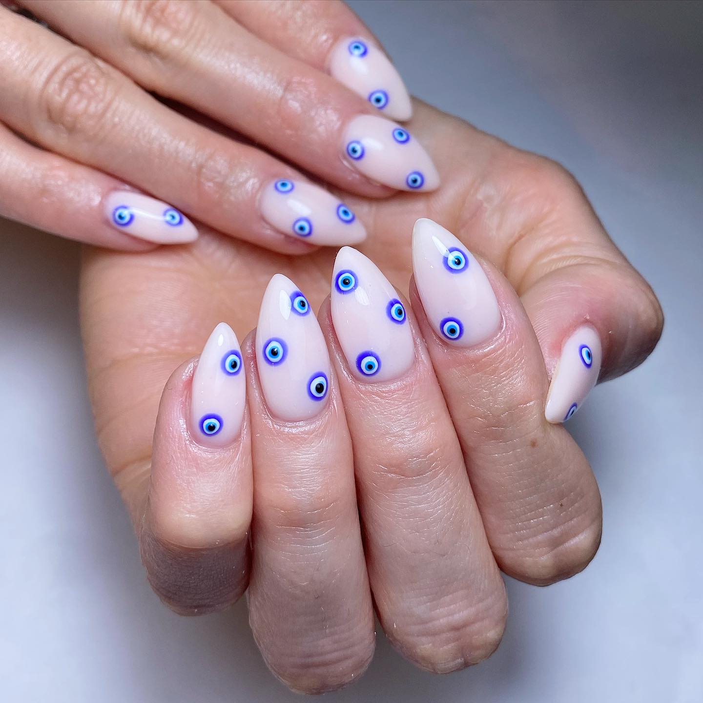 Elegant Stiletto Nails with Blue Eye Patterns