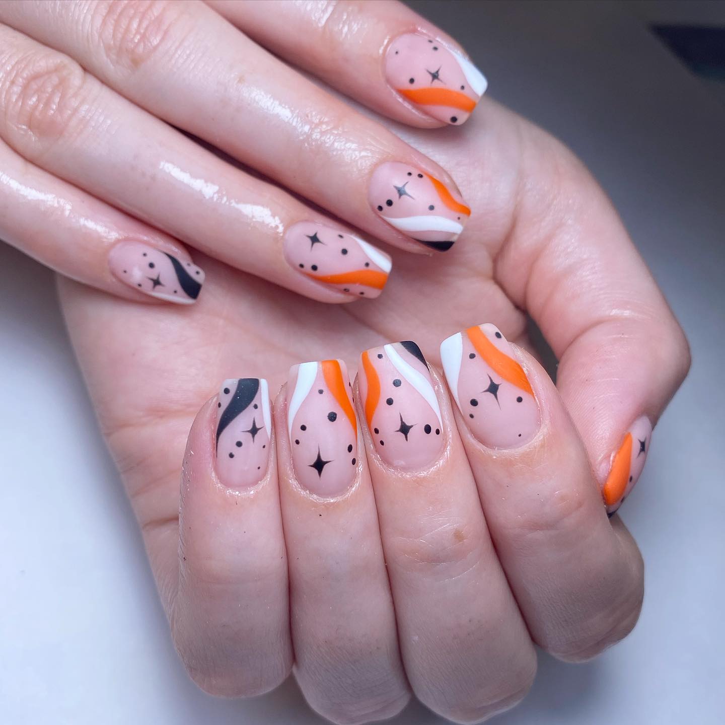 Artistic Orange and Black Nail Design