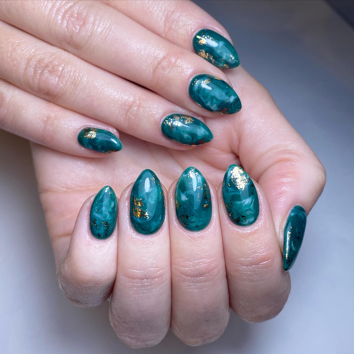Elegant Green Marble Nails with Gold Highlights