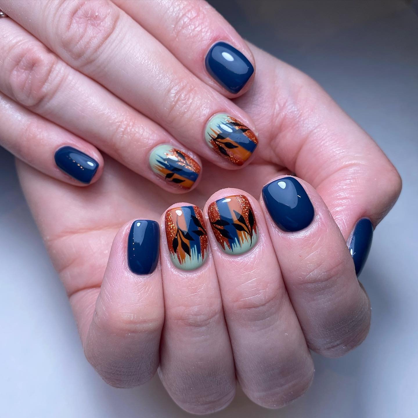 Artistic Blue and Copper Nail Design