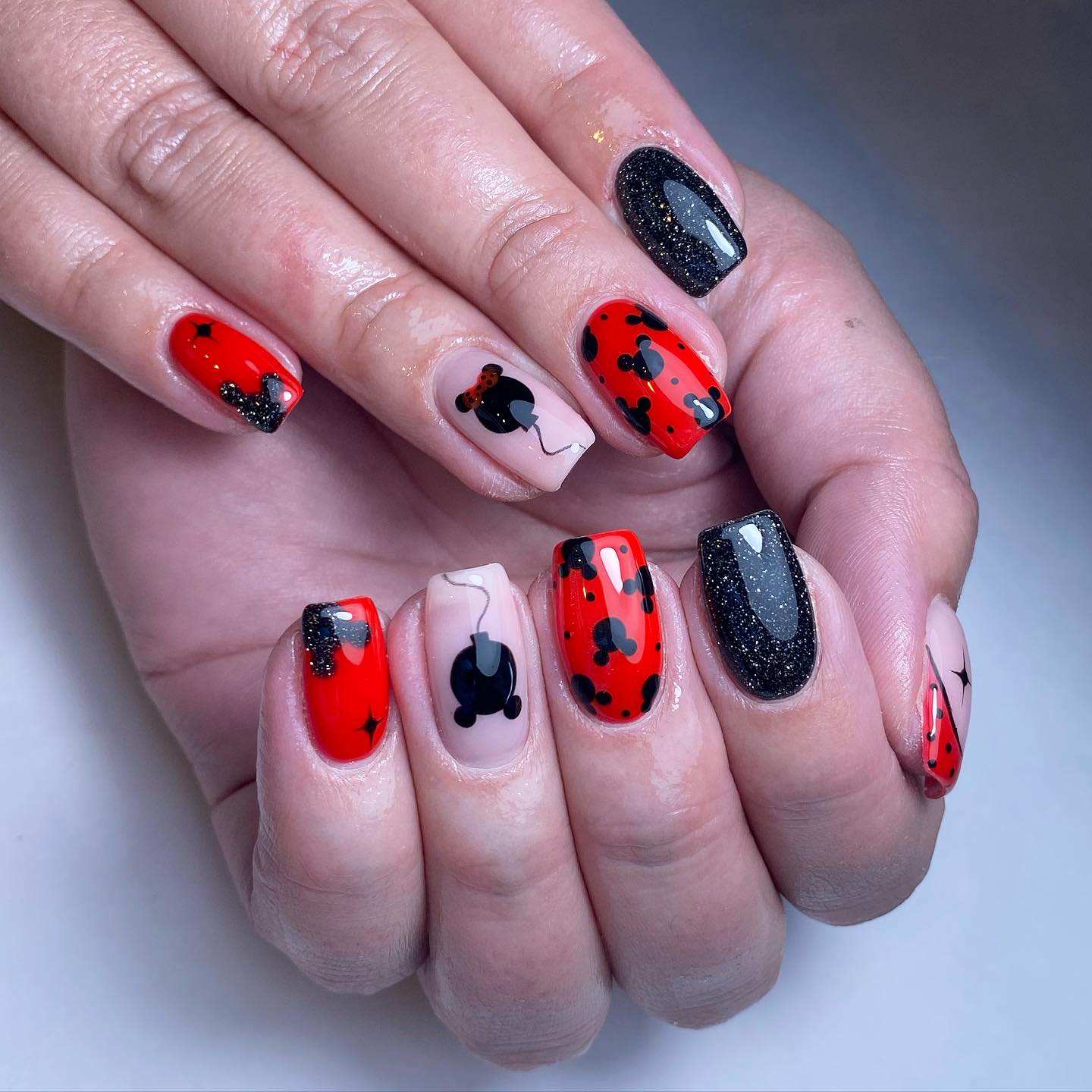 Artistic Red and Black Nail Design