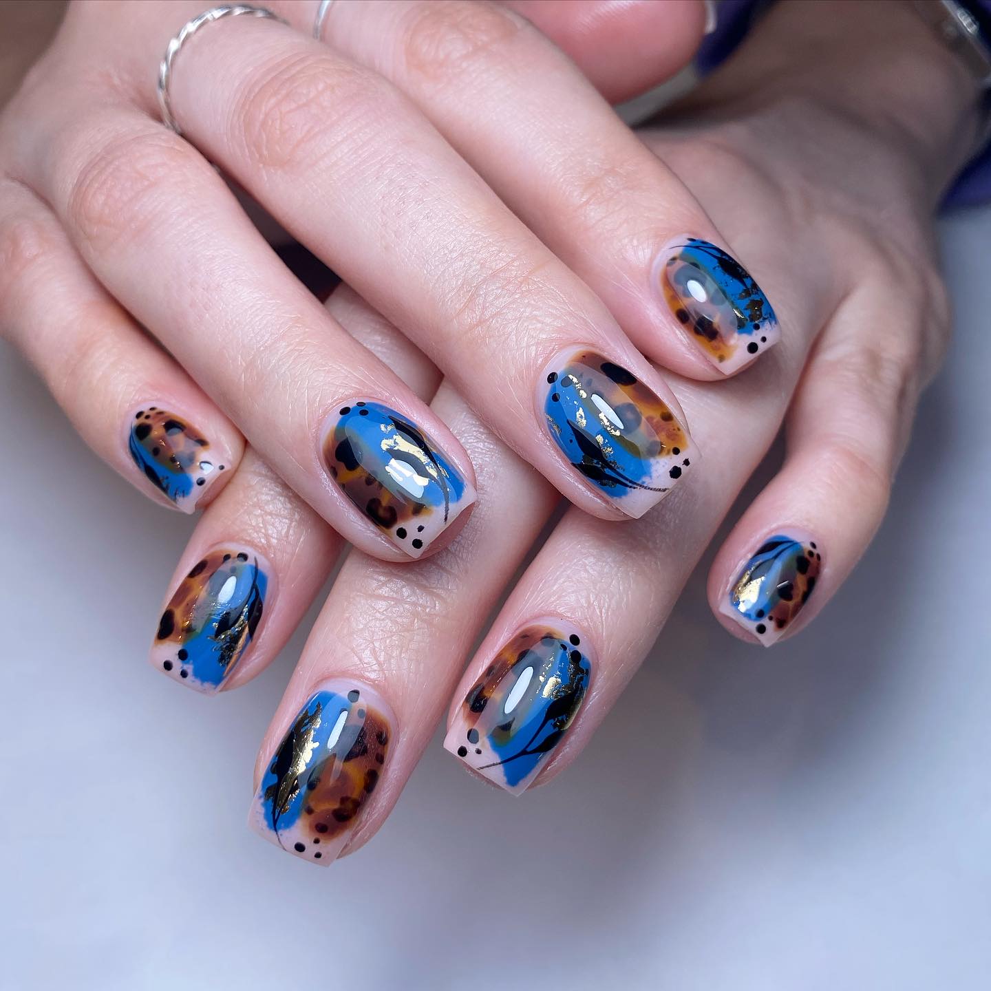 Artistic Blue and Brown Nail Art