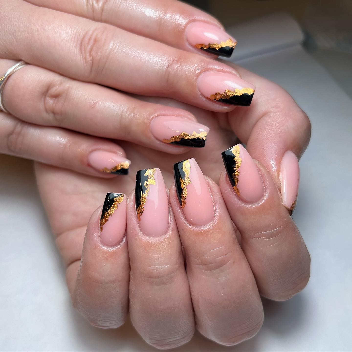 Artistic Nude and Black Nails with Gold Accents