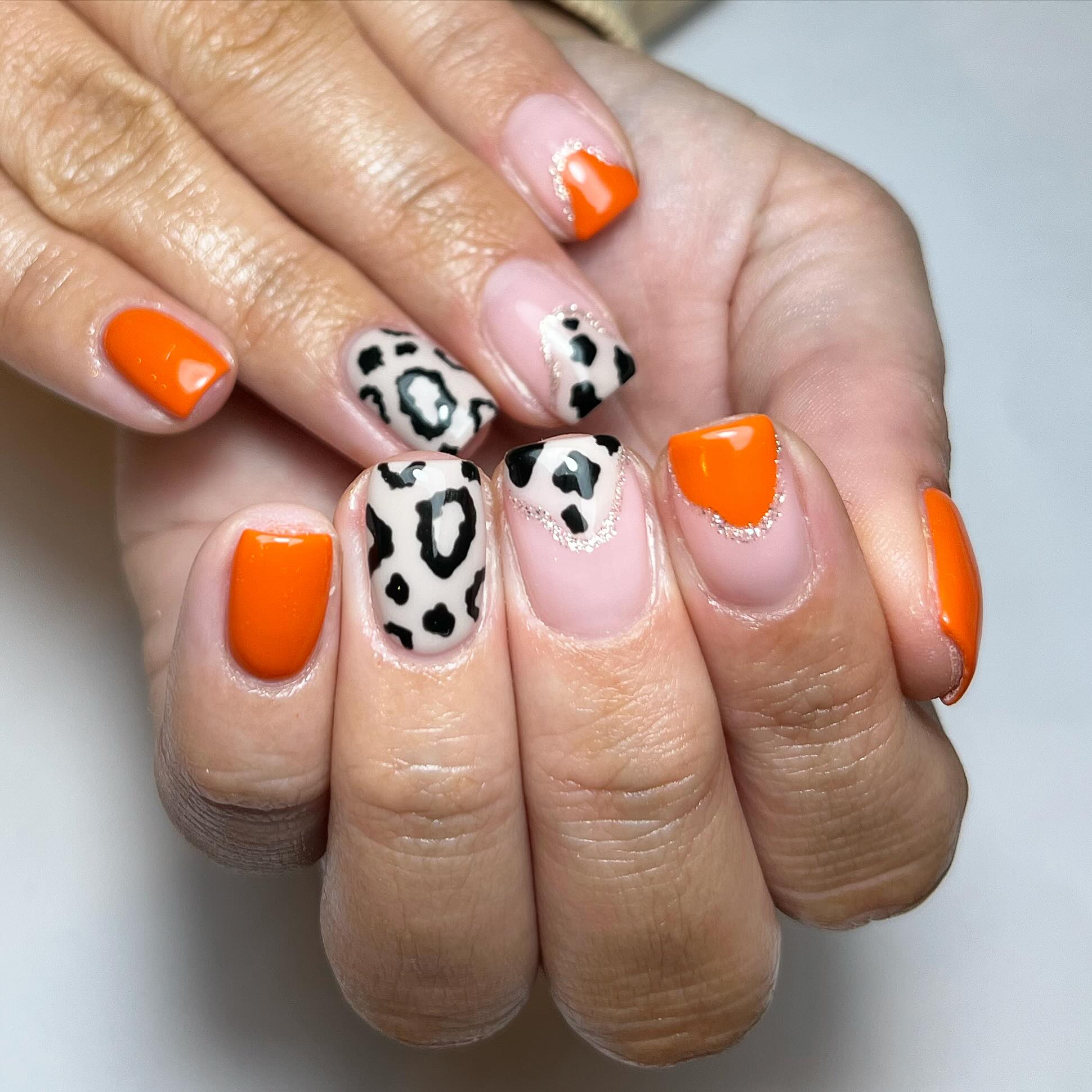 Vibrant Orange and Animal Print Nails