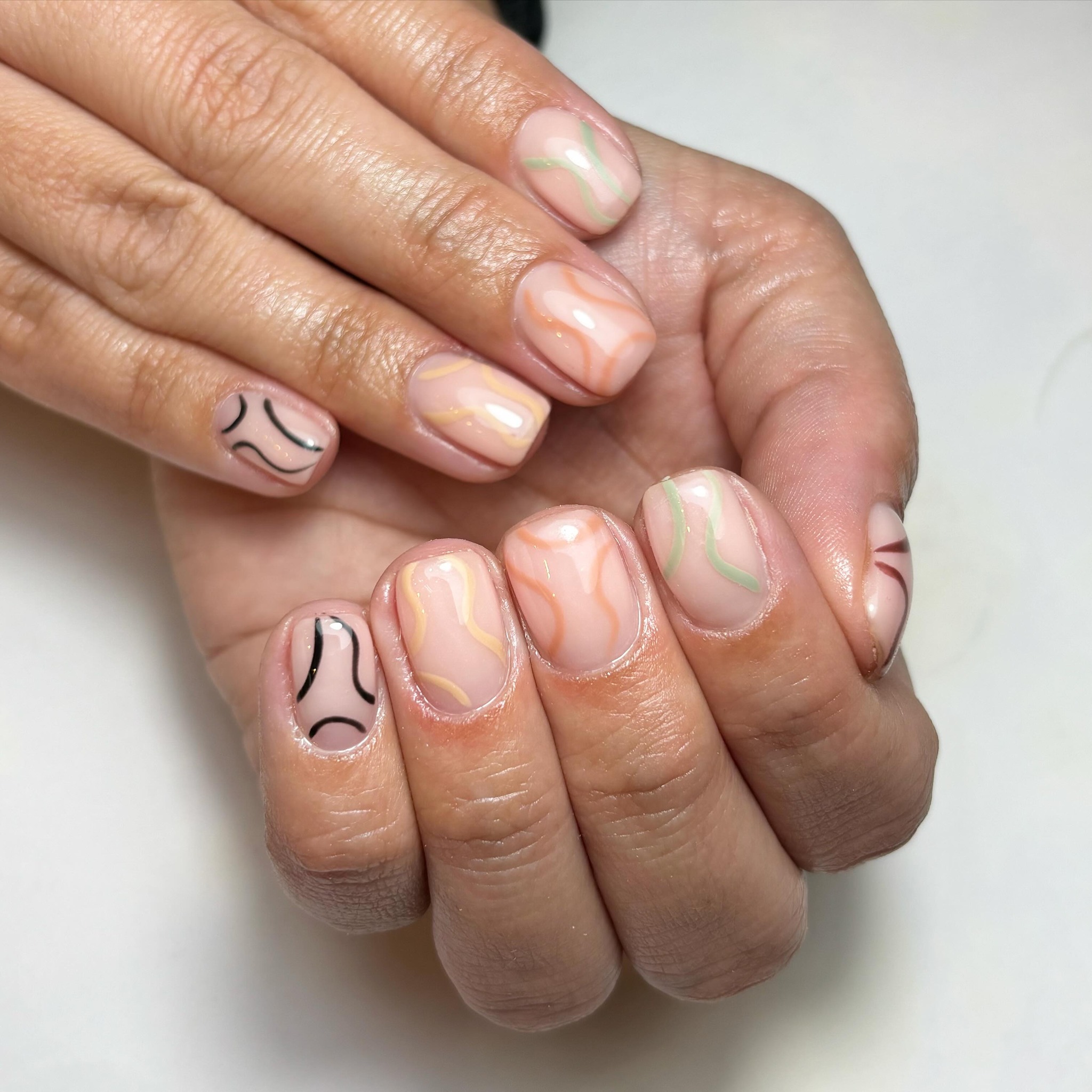 Artistic Nude Nails with Colorful Patterns