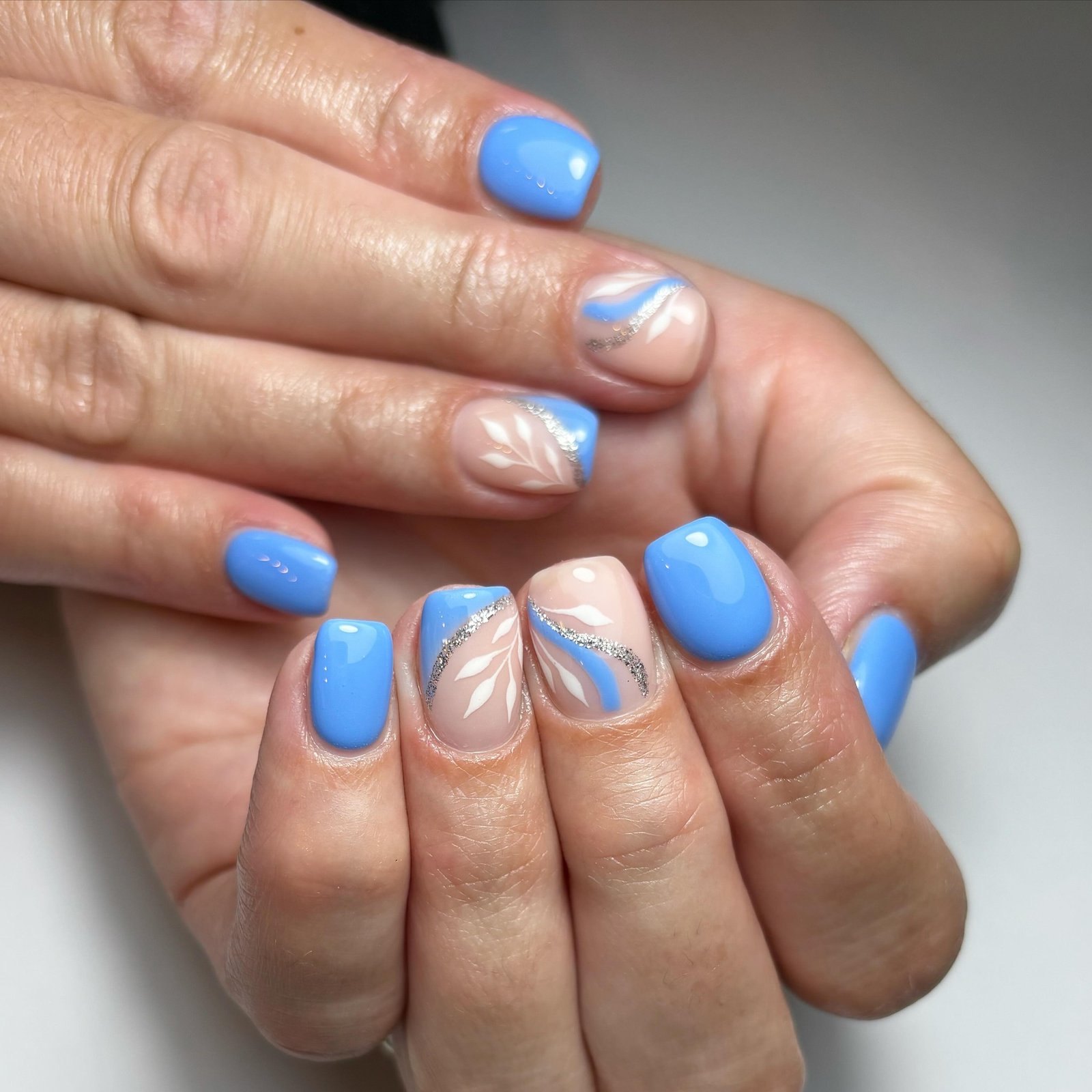 Artistic Blue and Nude Nail Design
