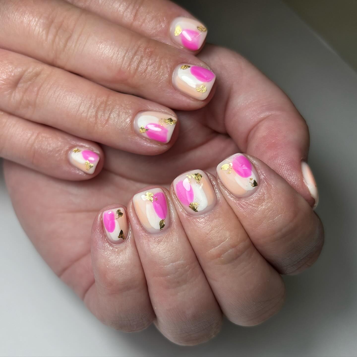 Artistic Nail Design with Pink and Gold Accents