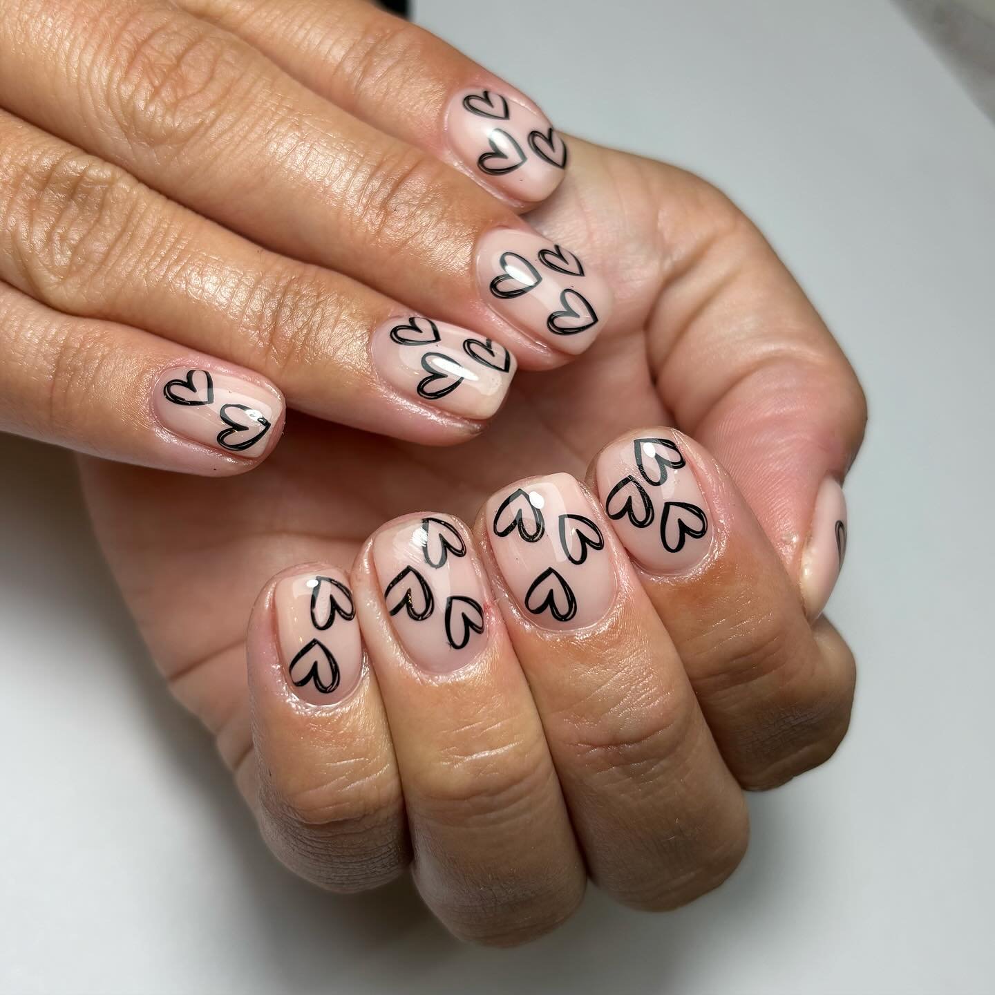 Nude Nails with Black Hearts