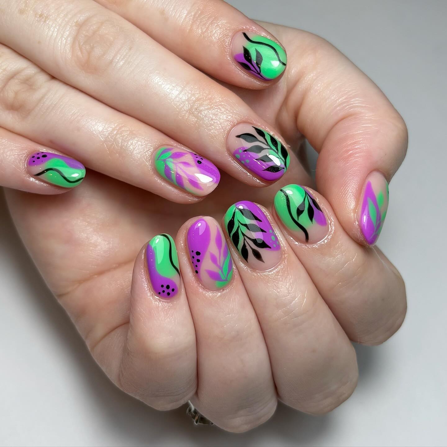 Artistic Green and Purple Nail Design