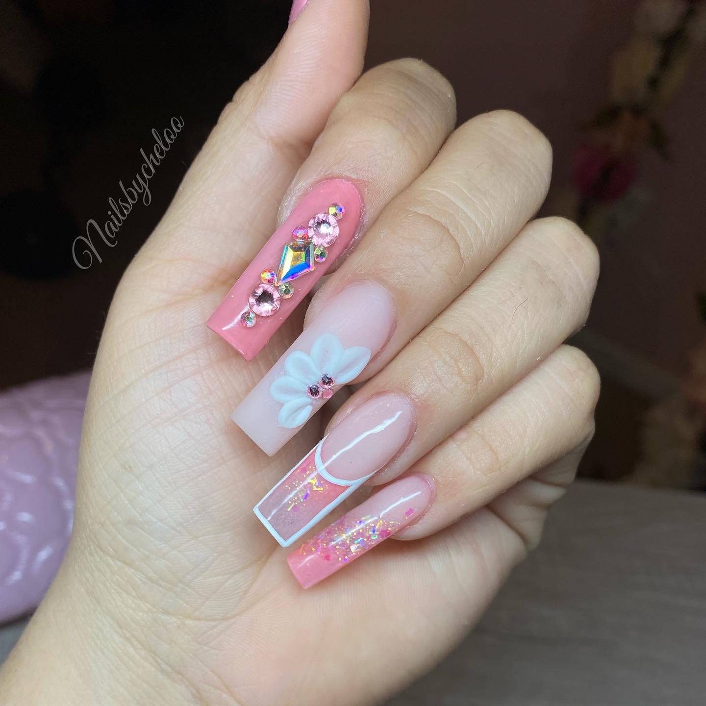 Stylish Pink Nail Art with Floral and Gem Accents