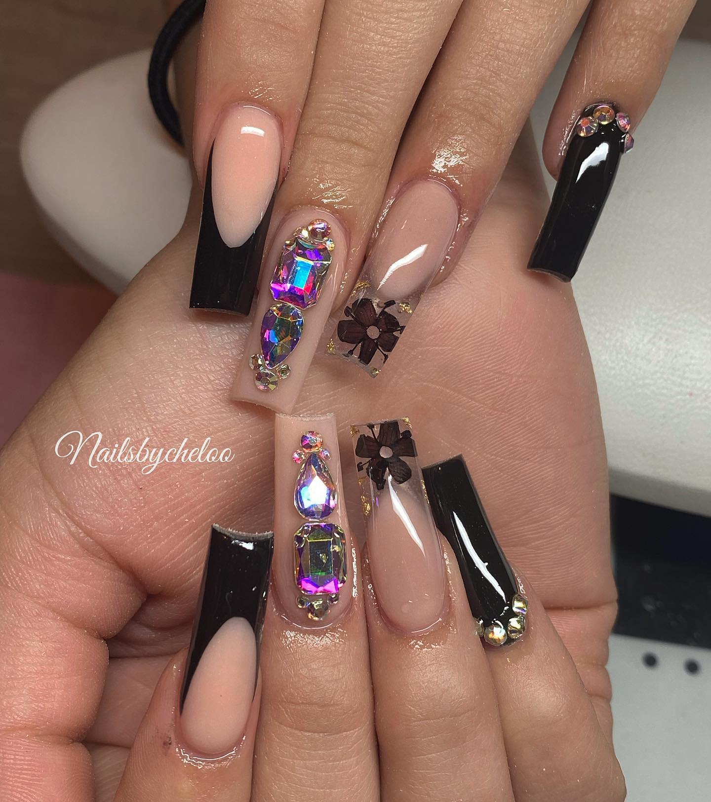 Elegant Black and Nude Nail Art with Gems
