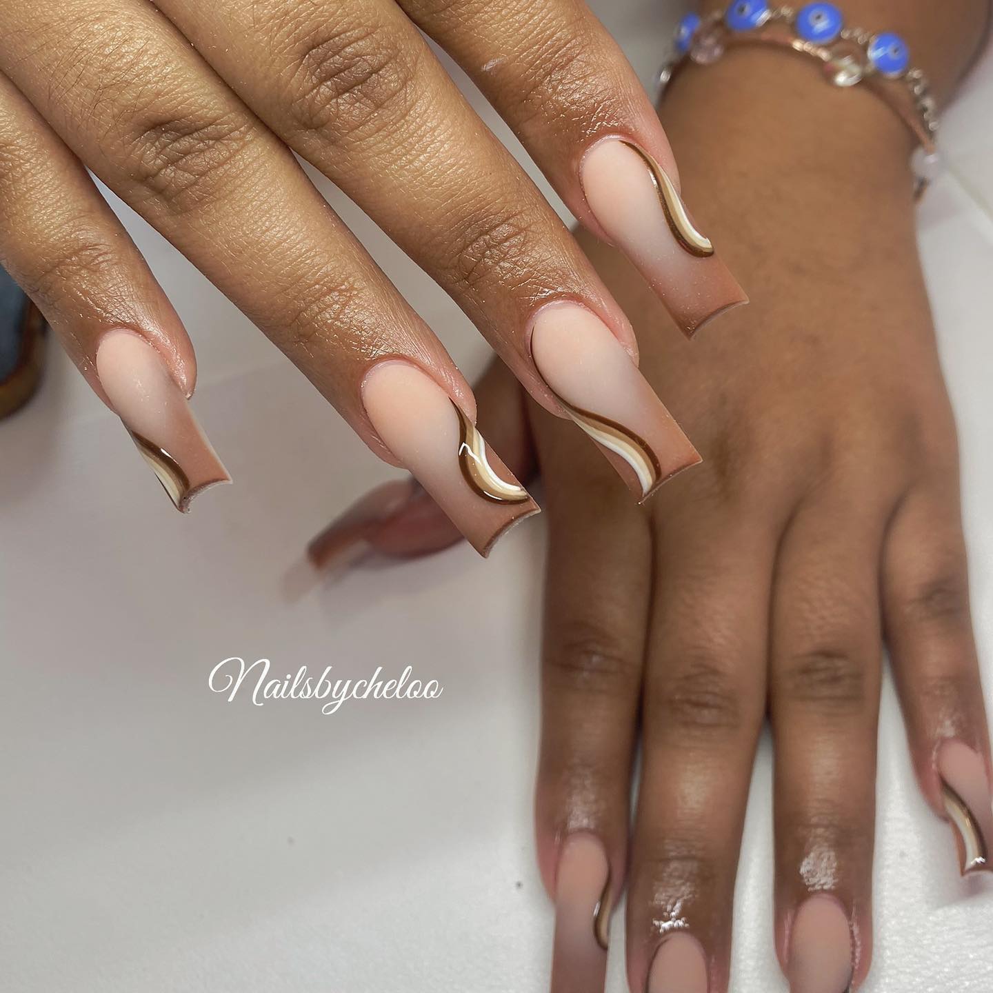 Artistic Nude Nails with Gold Accents