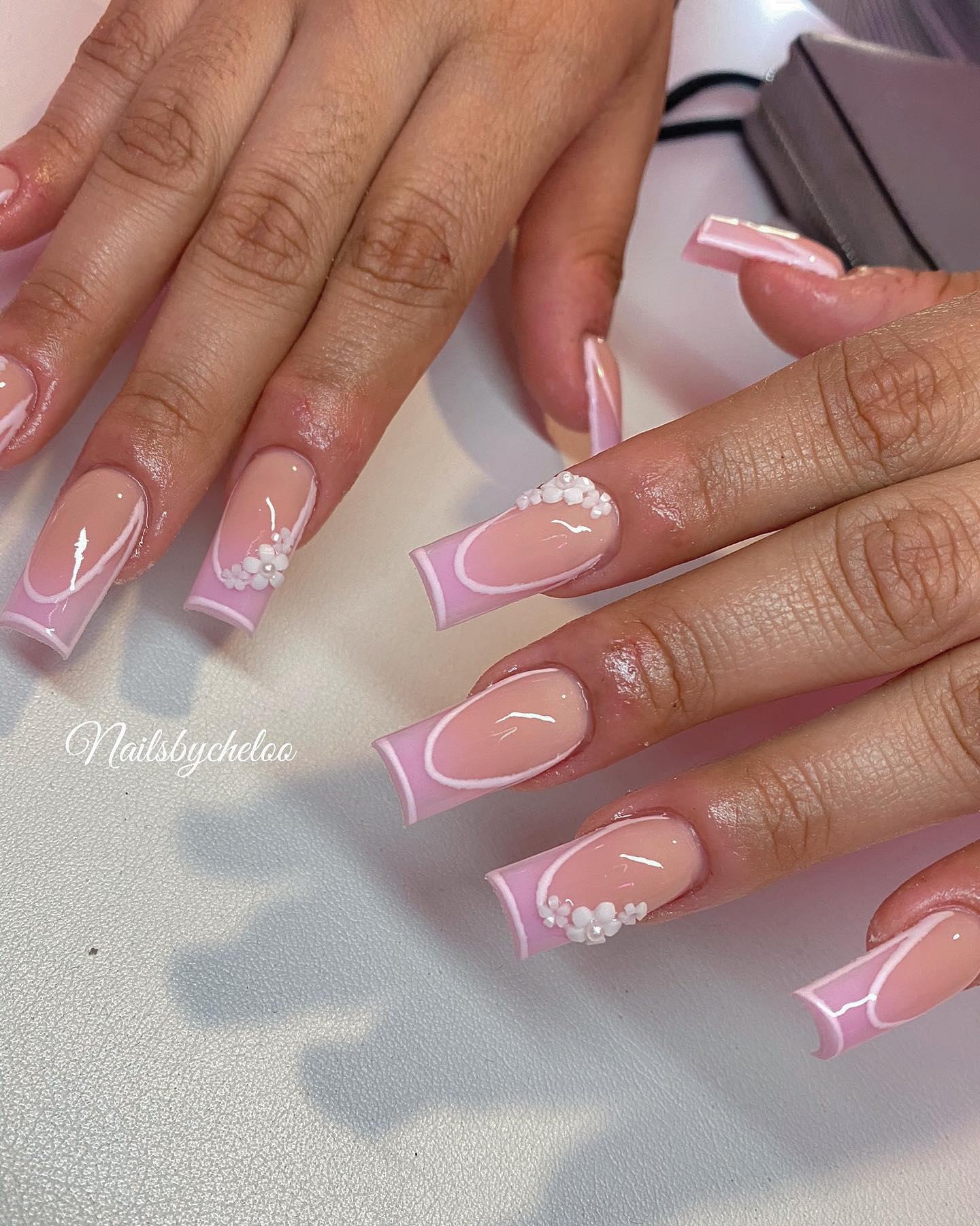 Elegant Pink French Tip Nails with Floral Accents
