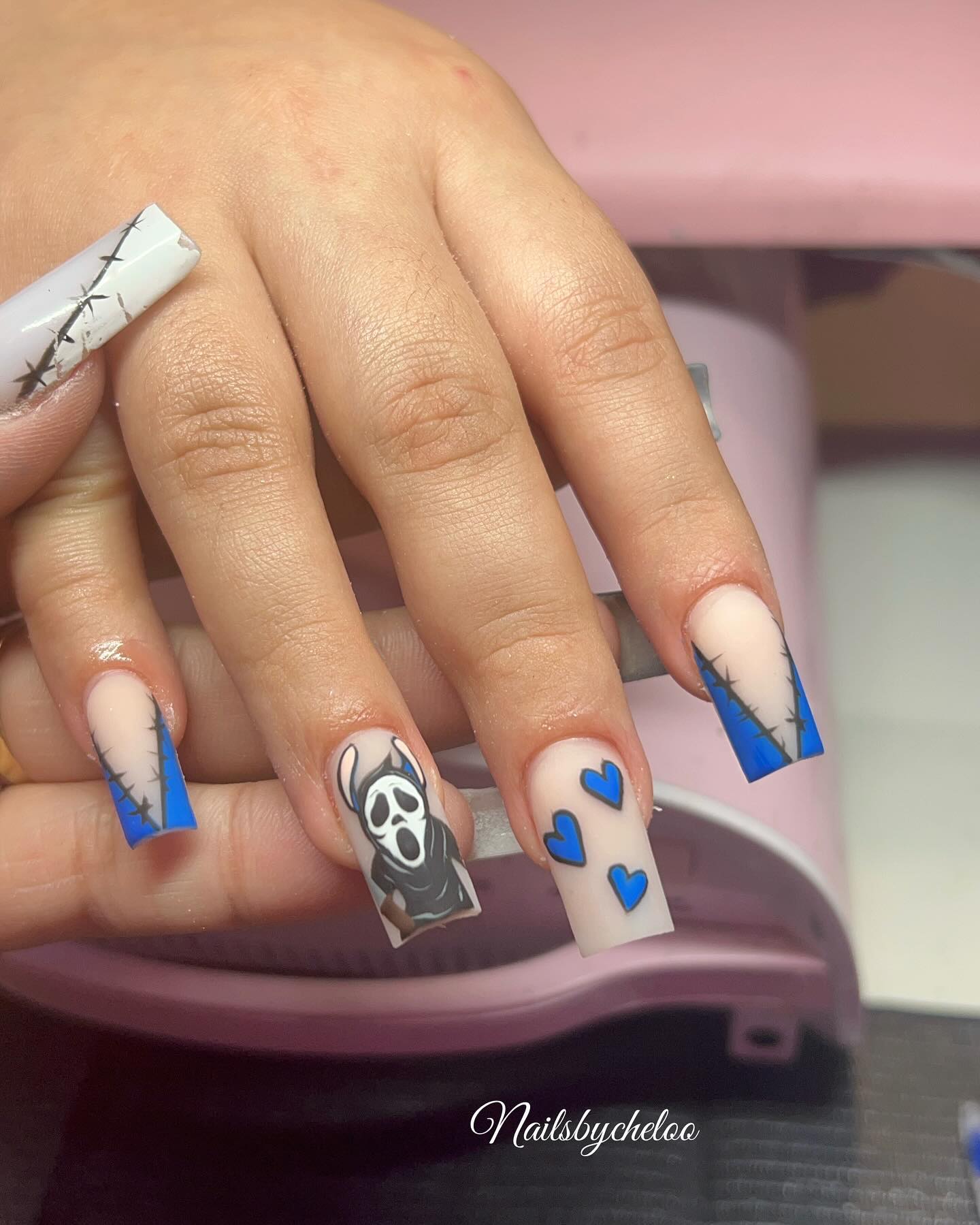 Artistic Blue and Nude Nails with Unique Designs