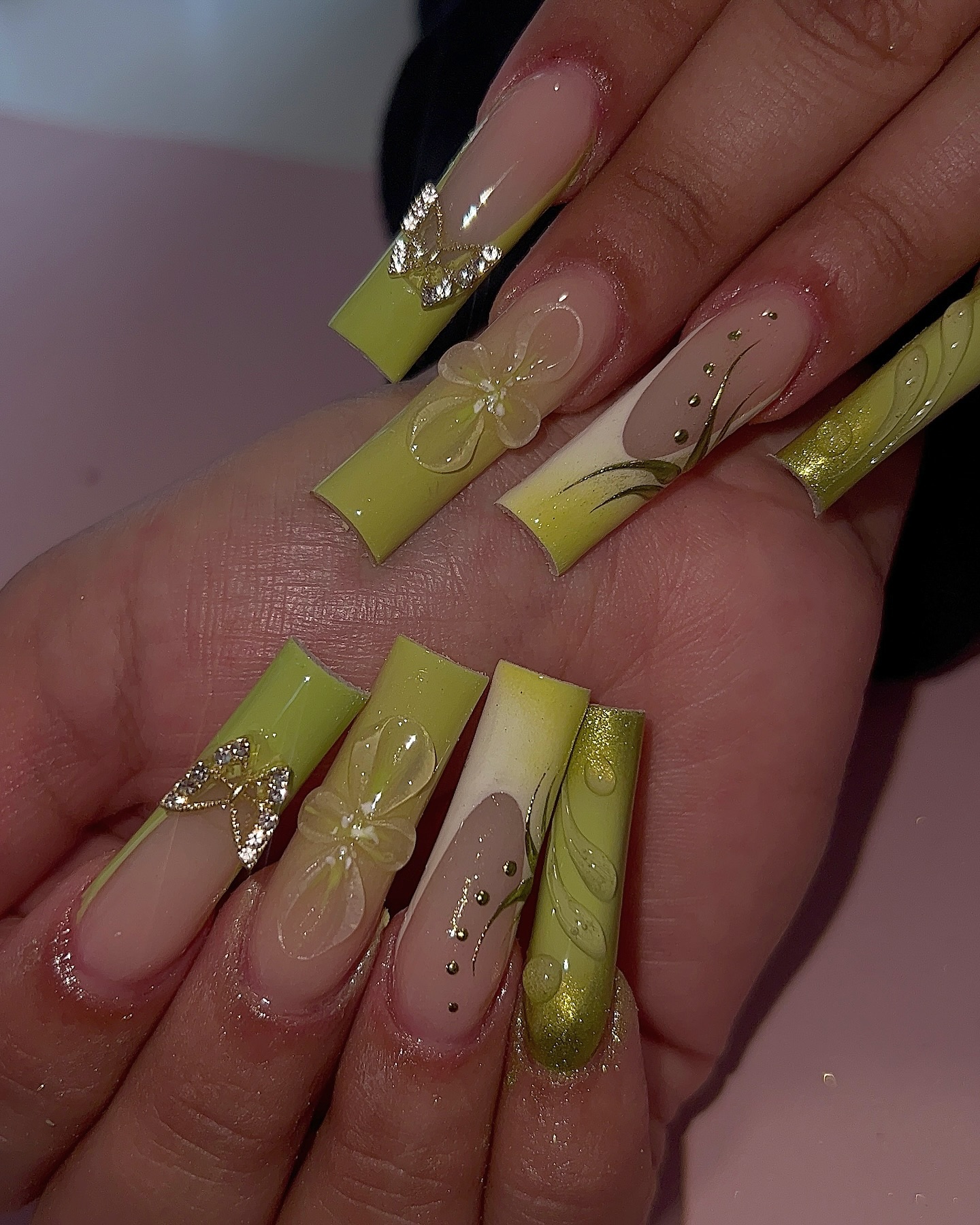 Artistic Green and Nude Nails with Butterfly Accents