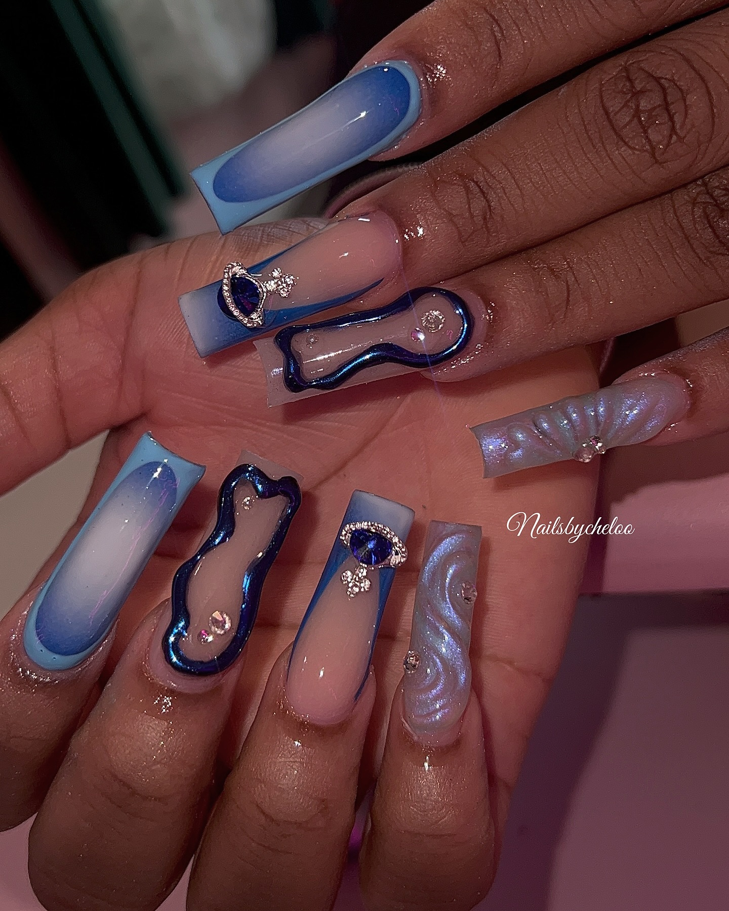 Artistic Blue Ombre Nails with Gems