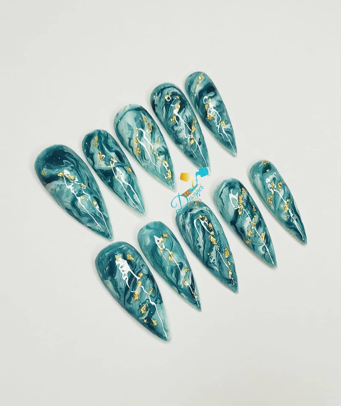 Artistic Stiletto Nails with Gold Accents